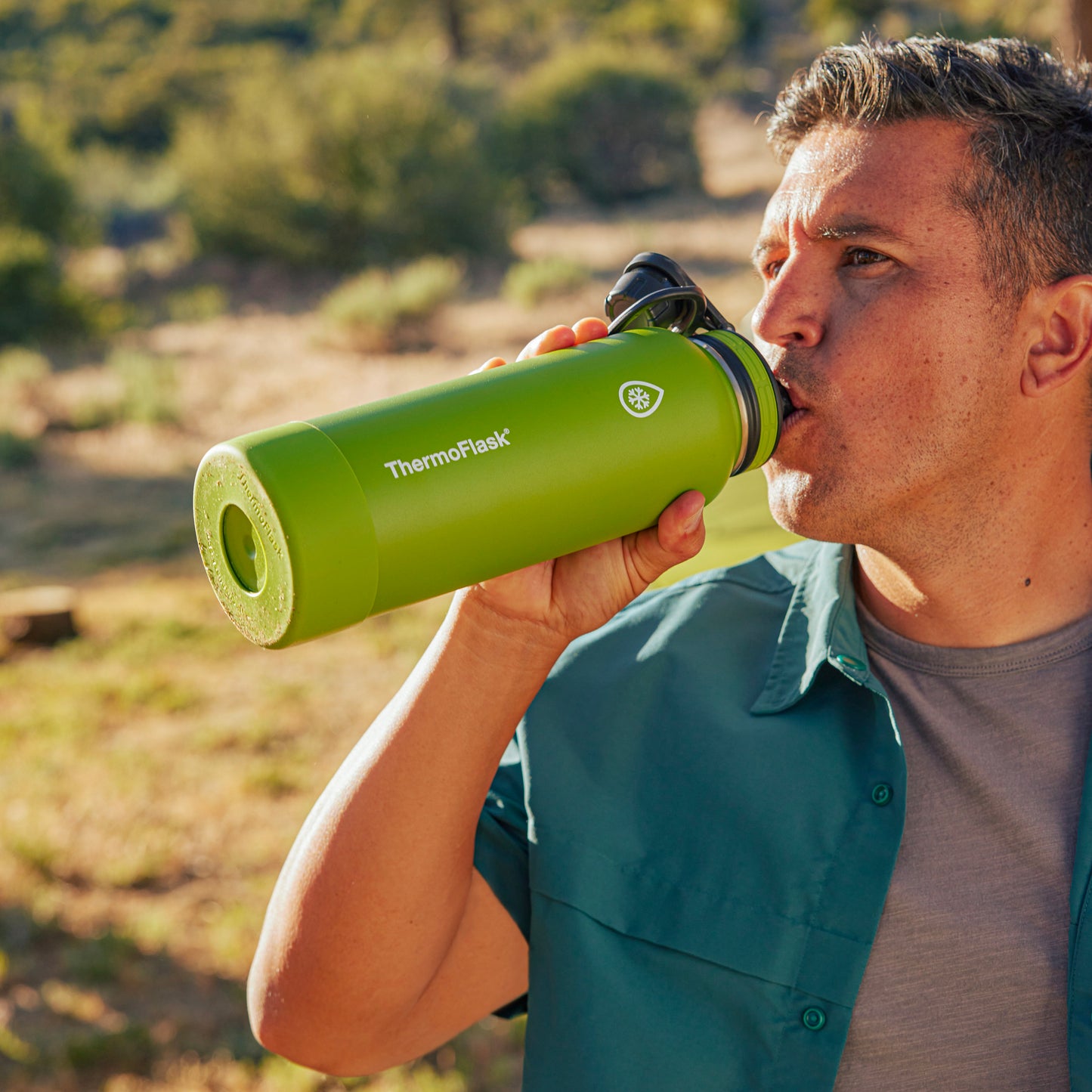 40oz Arctic/Grasshopper Bottles with Spout Lids. Man. holding 40oz Grasshopper bottle and drinking.