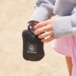 24oz Onyx Bottle Sling held by a female on a trail