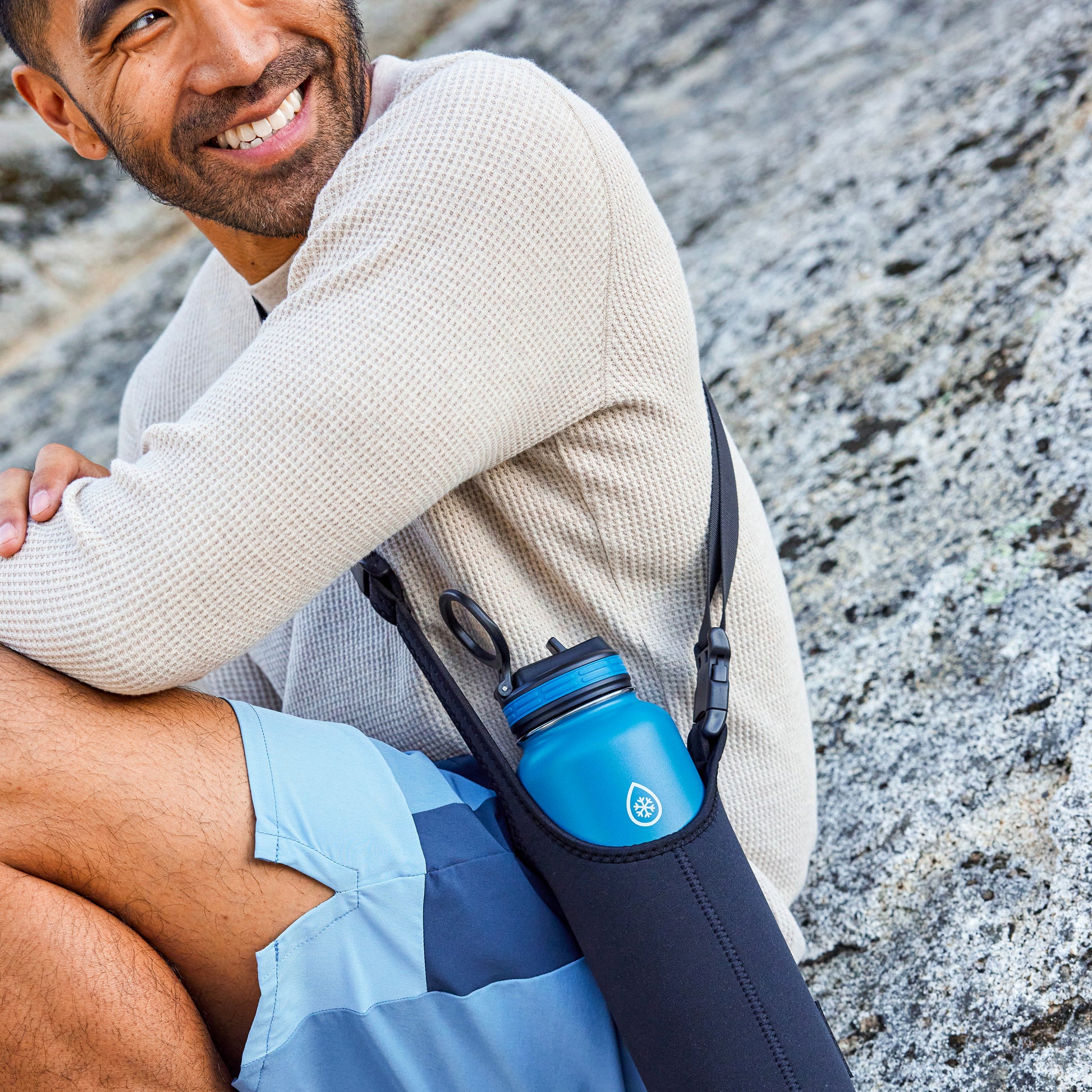 32/40oz Size Black ThermoFlask Bottle Sling carried by a man.