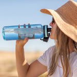 40oz Sky Tritan Bottle held by a woman drinking water.