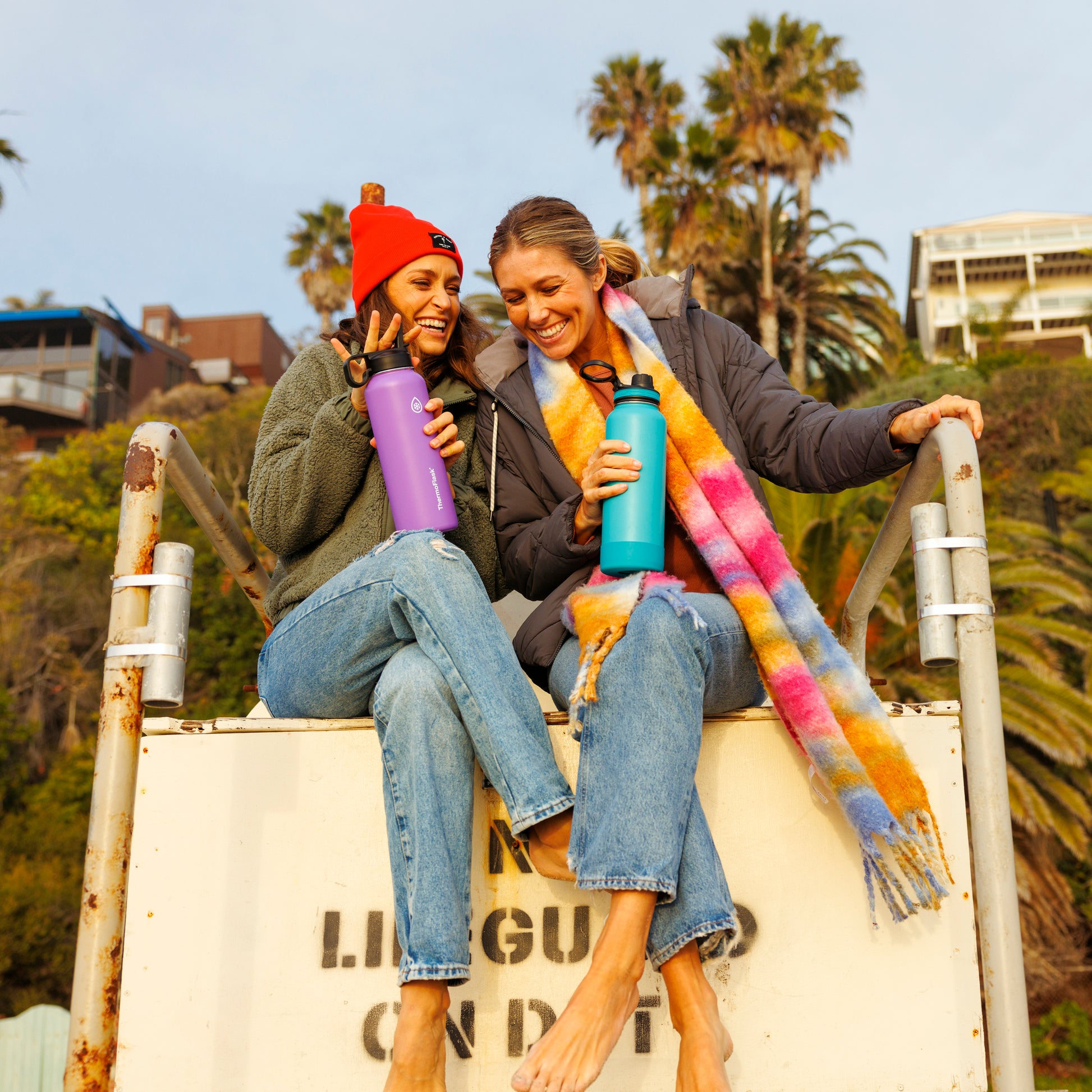 40oz Onyx/Splash Bottles with Spout Lids. Woman carrying splash bottle on a lifeguard tower with a friend.