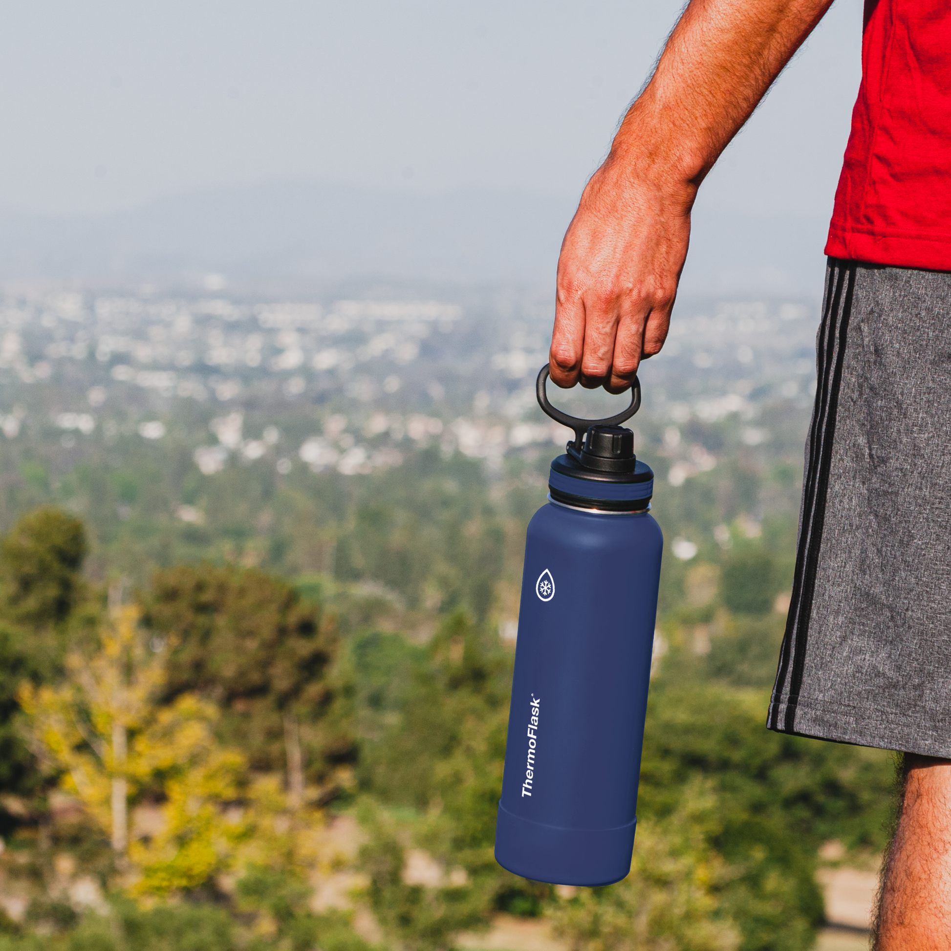 40oz Stone/Midnight Bottles with spout lids. Man holding midnight bottle.